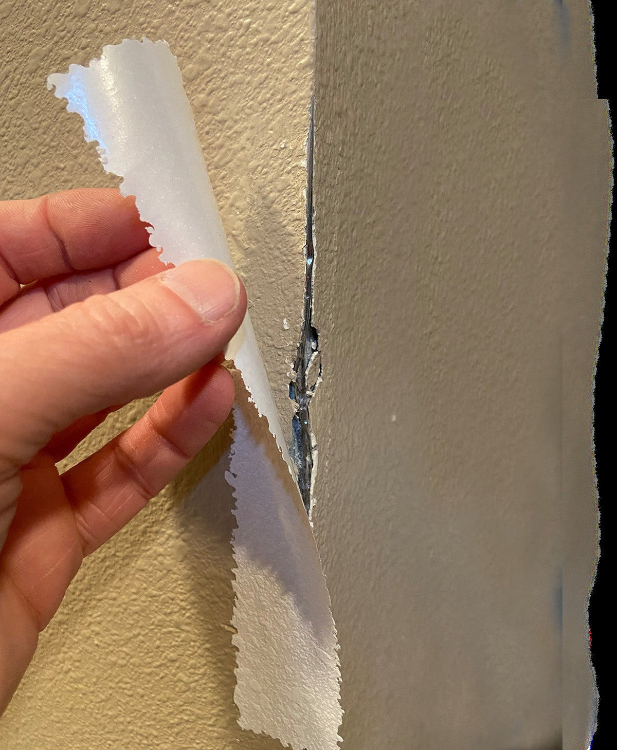 Stress Crack Tape being applied to repair an outside wall corner